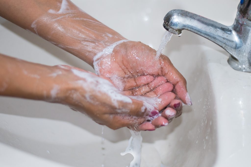 Image of washing hands to prevent the spread of COVID-19