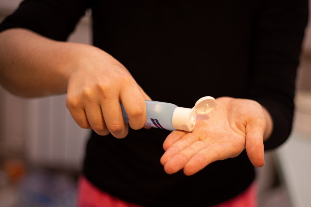 Image of person applying hand sanitizer to help prevent the spread of COVID-19